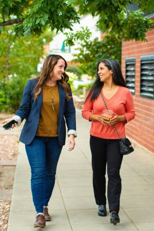 Two women walking and talking