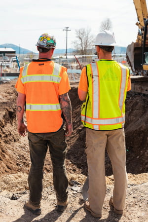 Construction workers looking at a site
